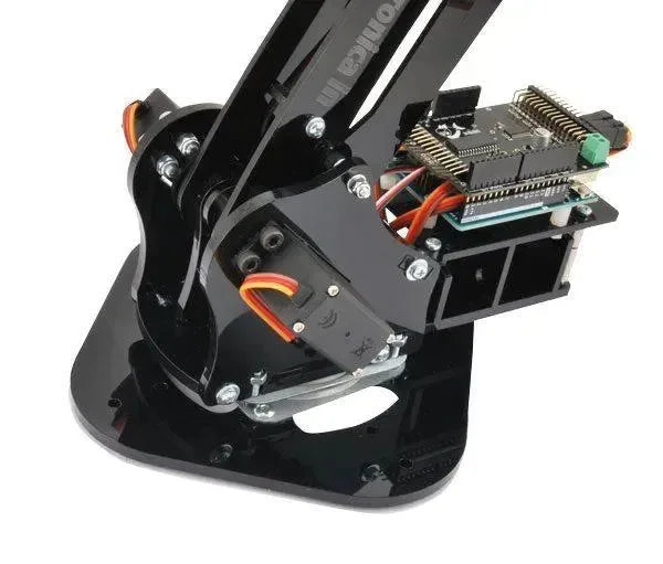 Braccio robotico articolato in plexiglass con base rotante, 4 gradi di libertà, componenti elettronici visibili.